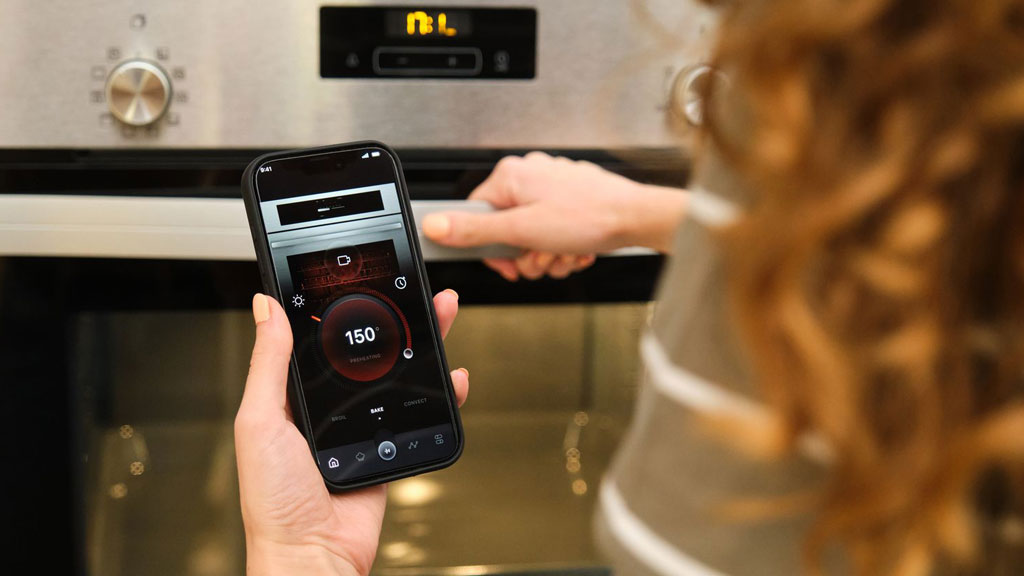 Intelligent oven with touchscreen display showing cooking temperature in modern kitchen