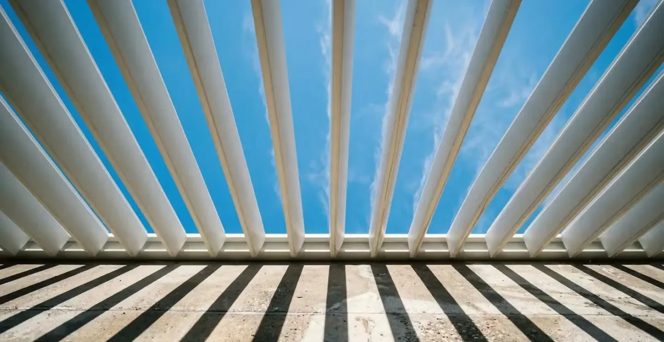 Motorized louvers angled against sun direction creating optimal shade while allowing airflow